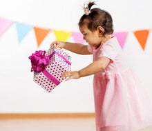 picture of a baby with a wrapped birthday gift photo by canva