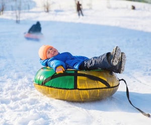 Lay back and let gravity do all the work with the best snow turning in Connecticut for families! Photo courtesy of Canva